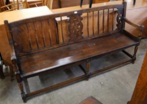A 19th Century style oak wheelback hall bench