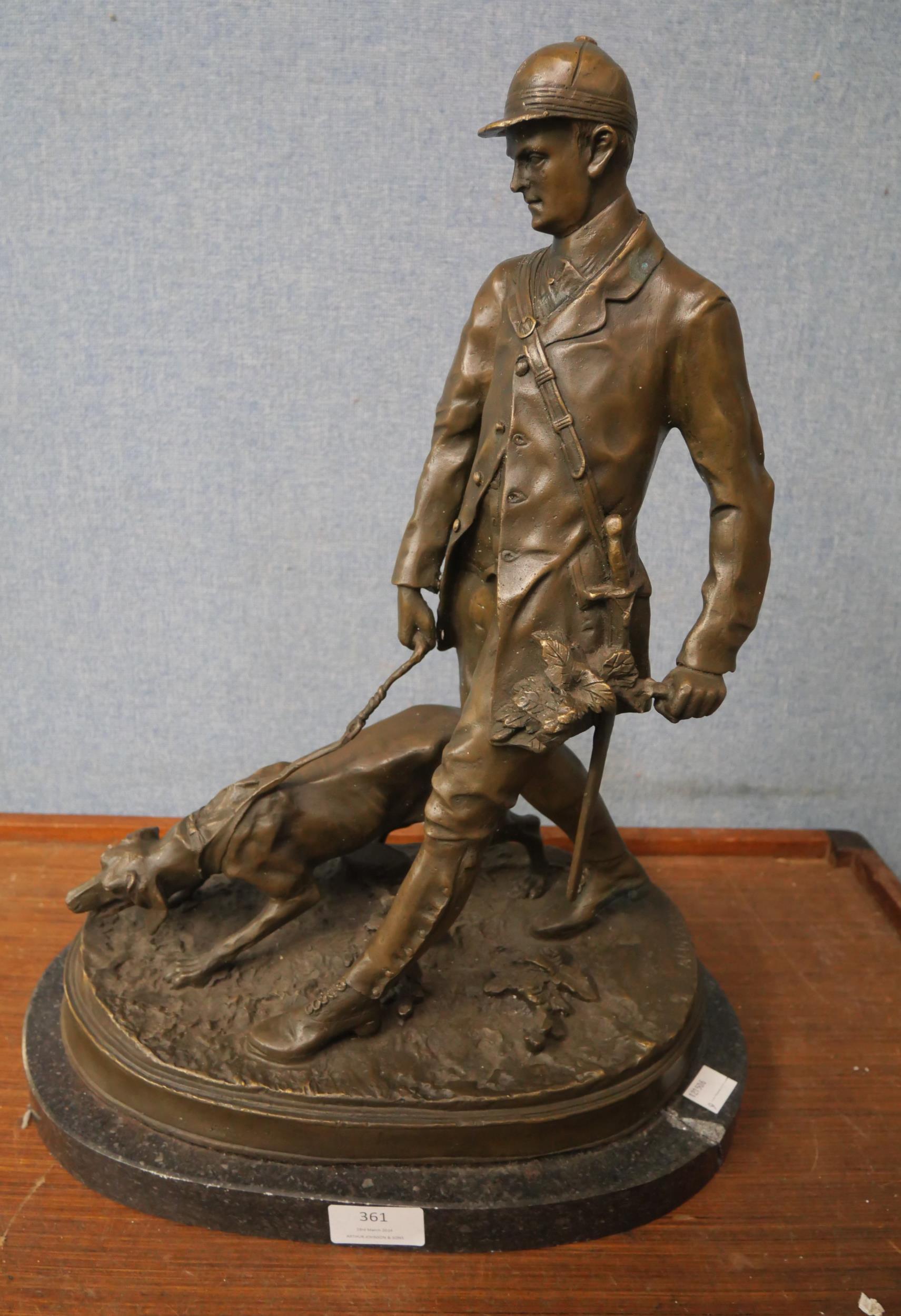 A bronze figure of a man and dog