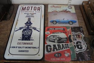 A tin motorcycle sign and five small signs