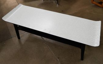 A Formica sleigh topped coffee table