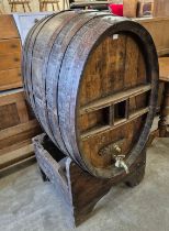 A large French coopered oak wine barrel on stand