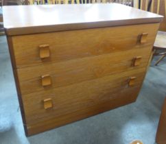 A teak chest of drawers