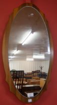 A teak oval framed mirror