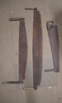 Three vintage cross cut saws