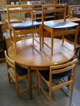 A teak circular dining table and six chairs