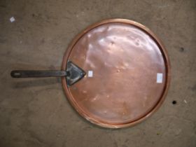 A Victorian copper pan lid