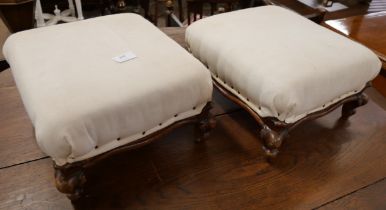 A pair of Victorian walnut footstools