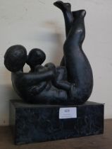 An abstract bronze figure of a mother and child