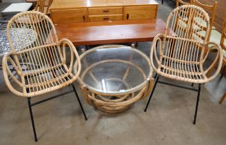 A circular bamboo and glass topped coffee table