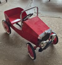 A child's toy pedal car