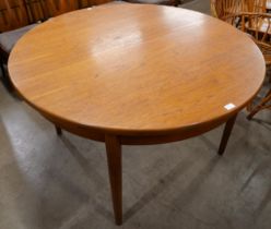 A Jentique 513 model circular extending dining table