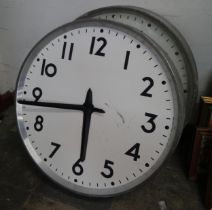 A pair of vintage industrial factory clocks