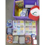 A large collection of Pokemon cards including six tins containing cards, a box of cards, other