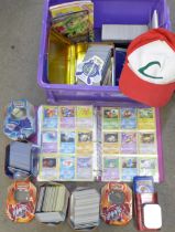 A large collection of Pokemon cards including six tins containing cards, a box of cards, other