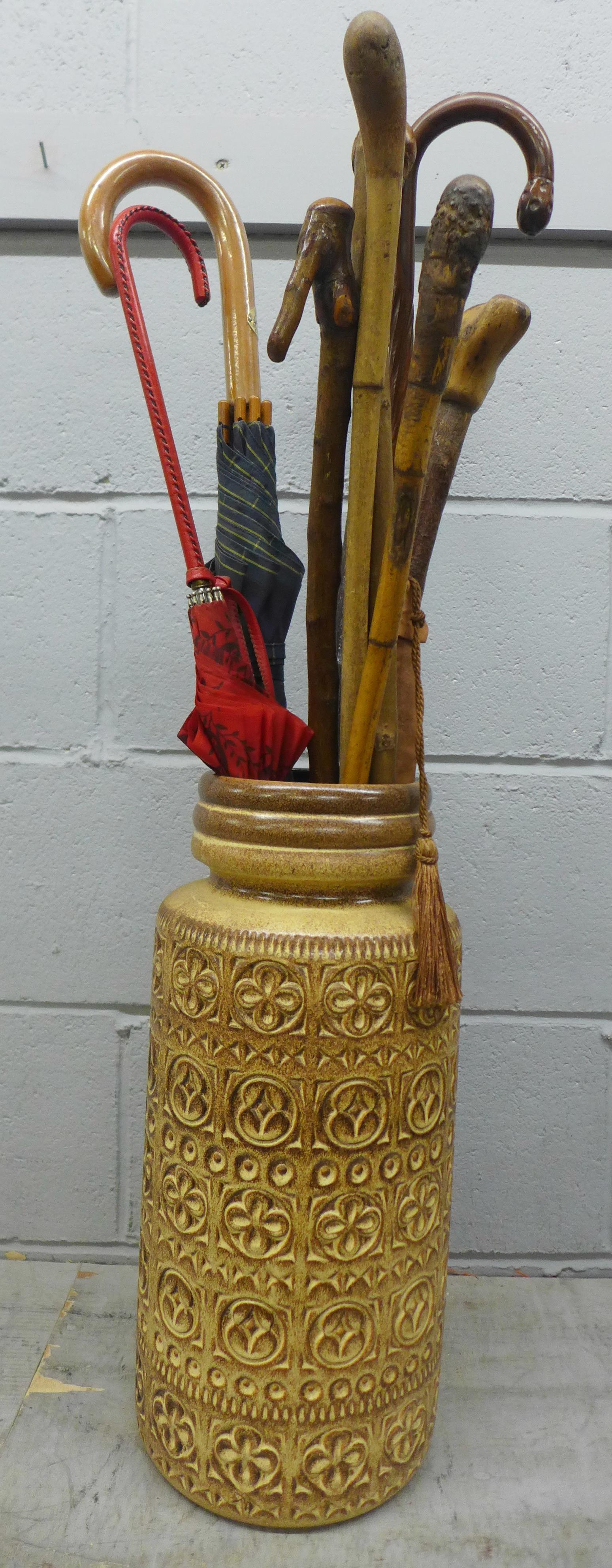 A West German vase/stick stand with a collection of walking sticks and umbrellas