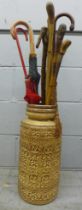 A West German vase/stick stand with a collection of walking sticks and umbrellas