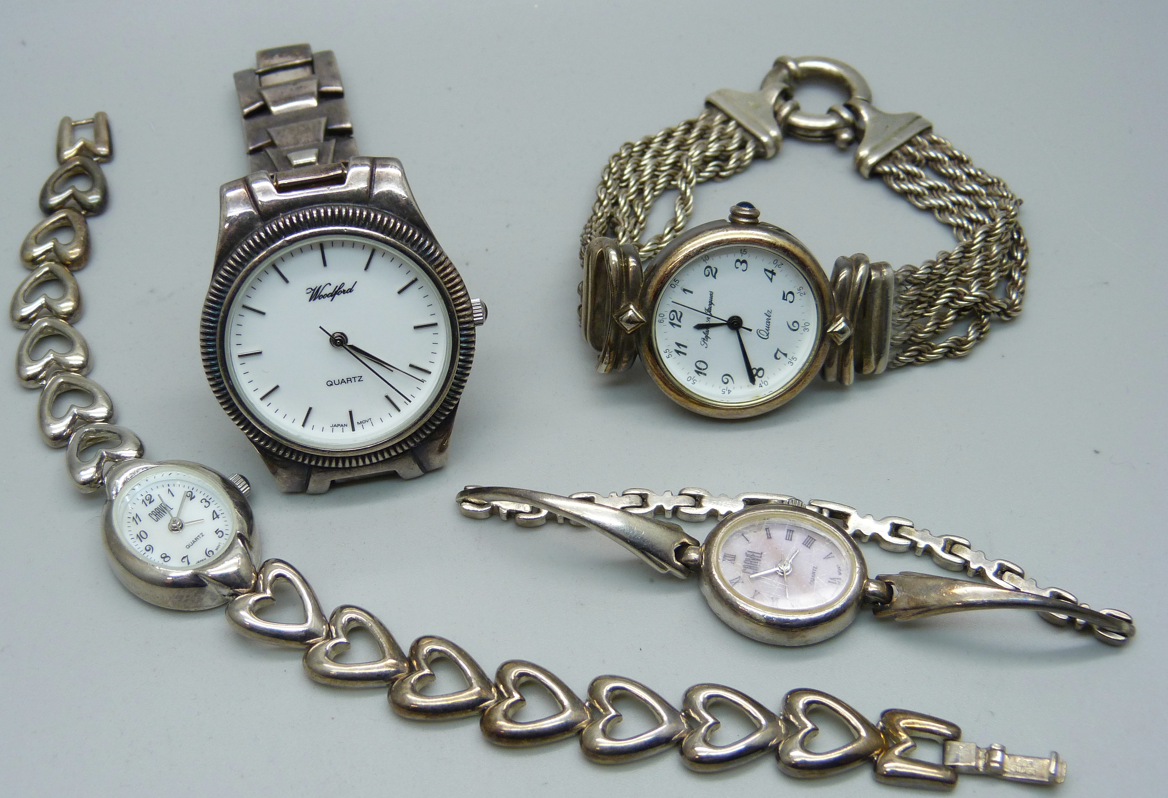 Four silver wristwatches