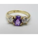 An 18ct gold, amethyst and diamond three stone ring, approximately 90ct weight, 3.9g, Q