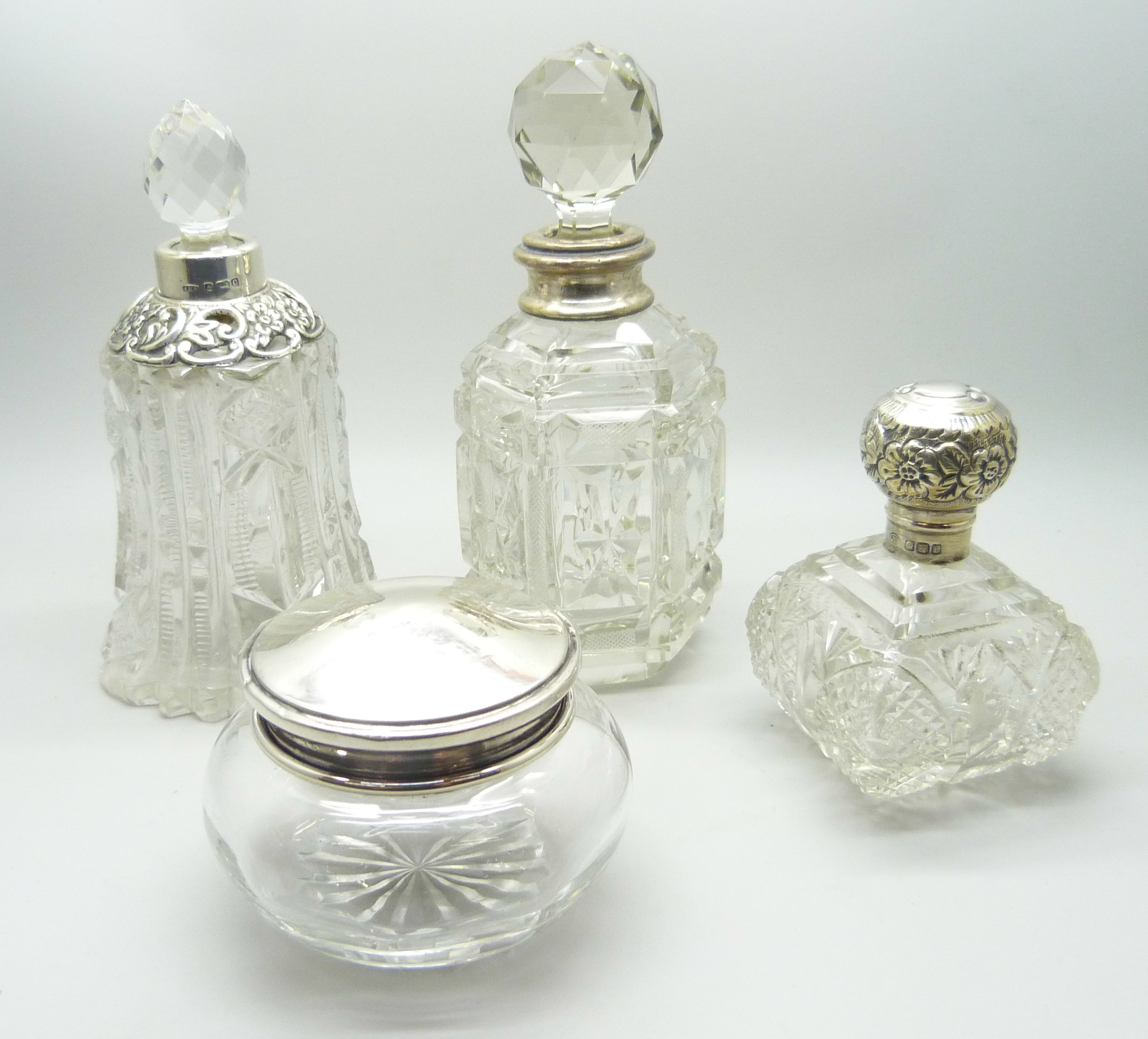 A silver mounted cut glass scent bottle in the shape of a bell, Birmingham 1902, two other silver