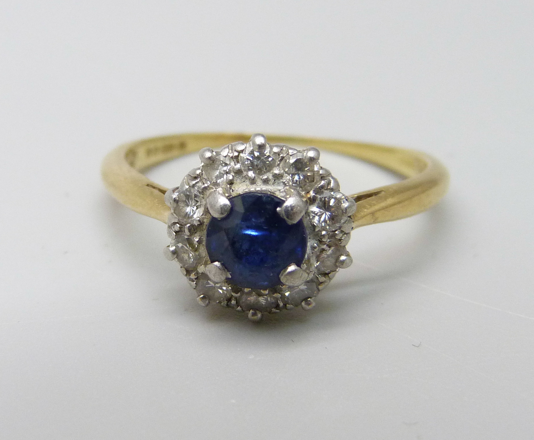 An 18ct gold and platinum set, diamond and sapphire ring, 3.1g, O, sapphire a/f