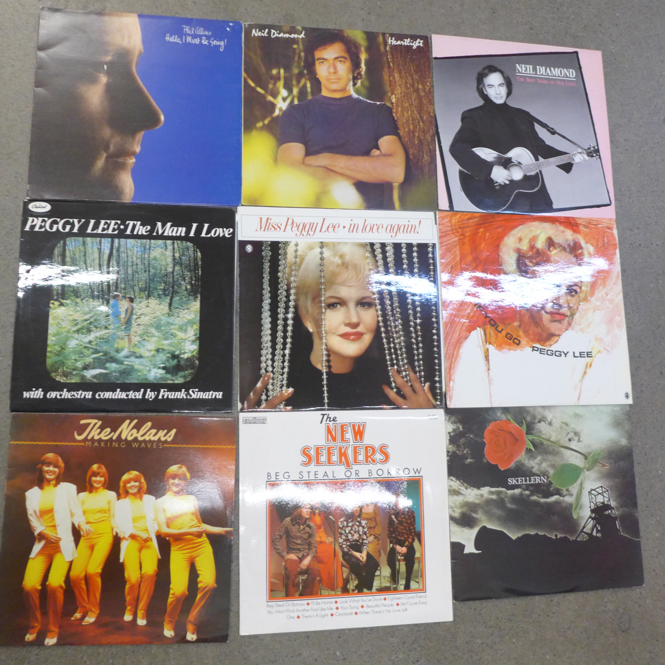 A collection of LP records including Phil Collins, Moody Blues, Robert Palmer, Steve Miller, etc.