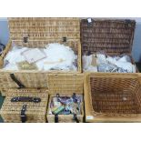 Four wicker baskets, one containing linen, one trims, lace and crochet edge, one haberdashery and