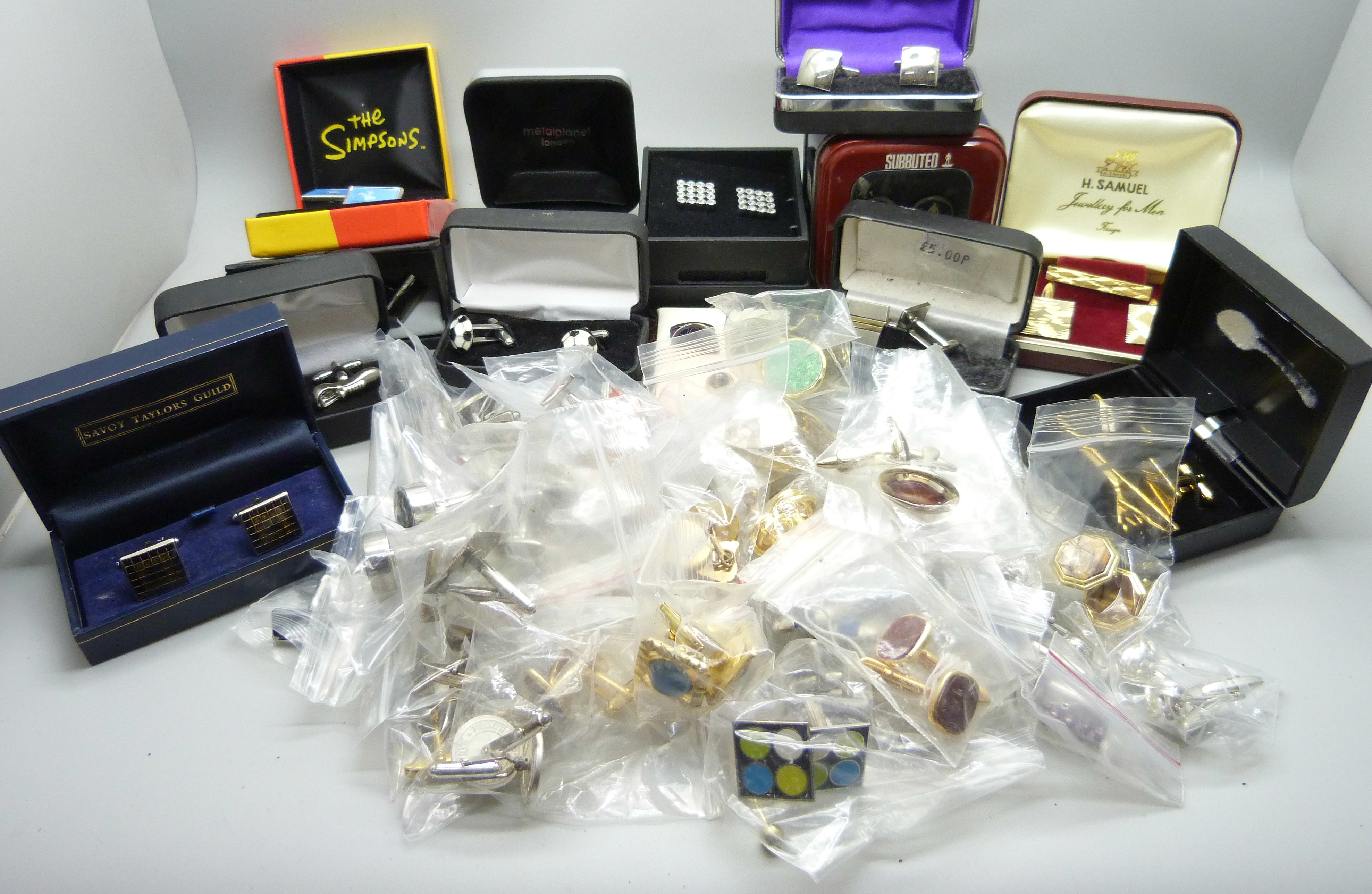 A collection of of cufflinks and tie-pins, some boxed