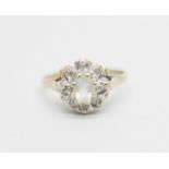 A 9ct gold ring set with a clear central stone and diamond chip halo, 2.2g, O