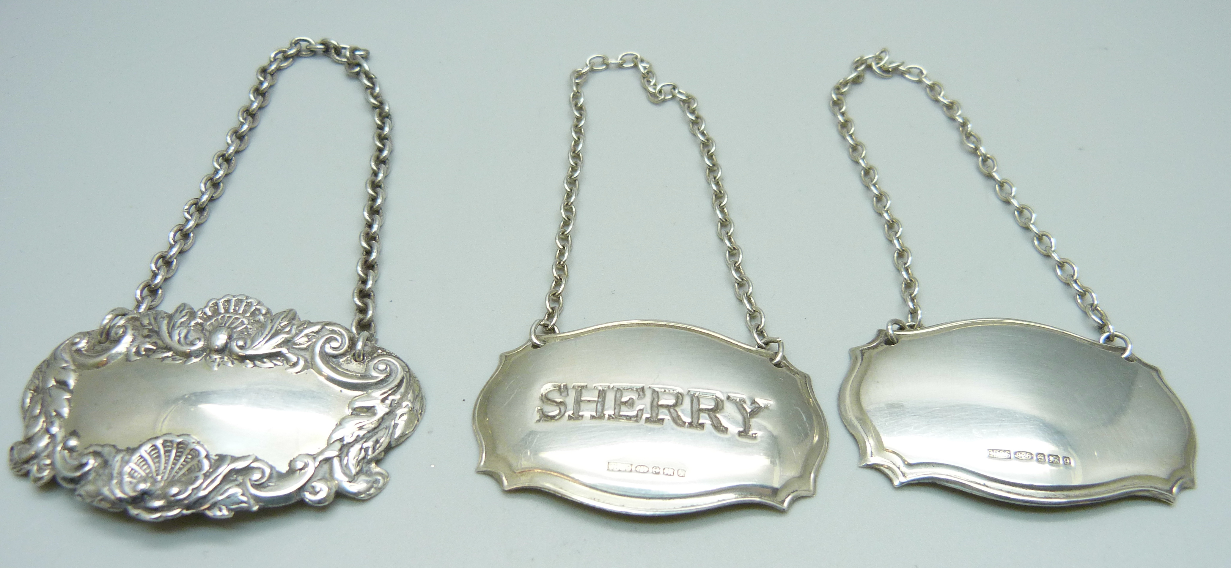 Three silver wine labels, one marked sherry, two unmarked