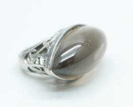 A silver ring set with a large brown cabochon stone, 19.5g, N, 36mm wide