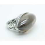 A silver ring set with a large brown cabochon stone, 19.5g, N, 36mm wide