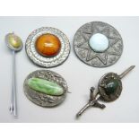 Two brooches set with Ruskin style plaques and three other brooches