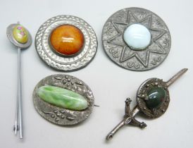 Two brooches set with Ruskin style plaques and three other brooches