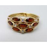 A yellow metal garnet and diamond cluster ring, 3.6g, T, continental control mark on the outside