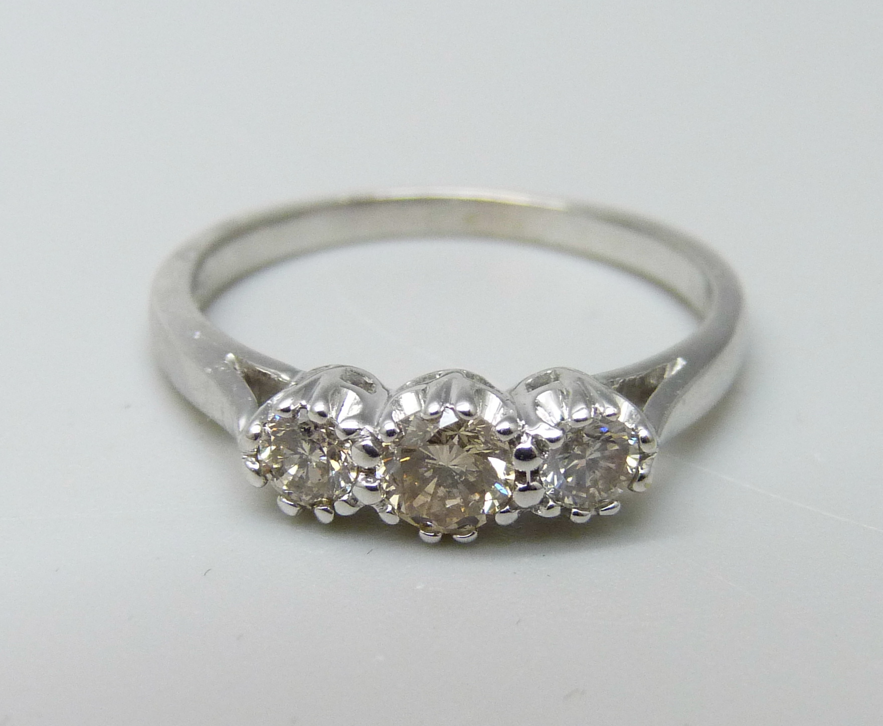 An 18ct white gold and diamond trilogy ring, 0.5ct total diamond weight marked on the shank, 3.2g, O