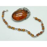 A silver and amber brooch and bracelet