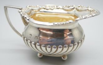 A small Victorian silver jug, scroll mount and half fluted decoration, London 1894, 76g