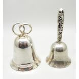 A silver bell with pierced handle and one other bell