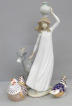 Two Royal Crown Derby paperweights and a Nao figure of a girl with goat