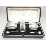 A silver condiment set, London 1940, and two silver spoons, 121g