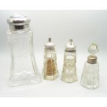 A silver top cut glass shaker, Birmingham 1934, a pair of silver topped salts and a silver mounted