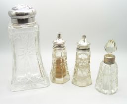 A silver top cut glass shaker, Birmingham 1934, a pair of silver topped salts and a silver mounted