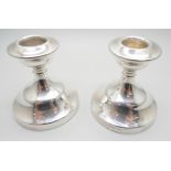 A matched pair of silver dwarf candlesticks