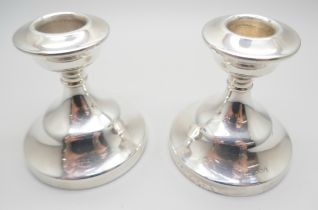 A matched pair of silver dwarf candlesticks