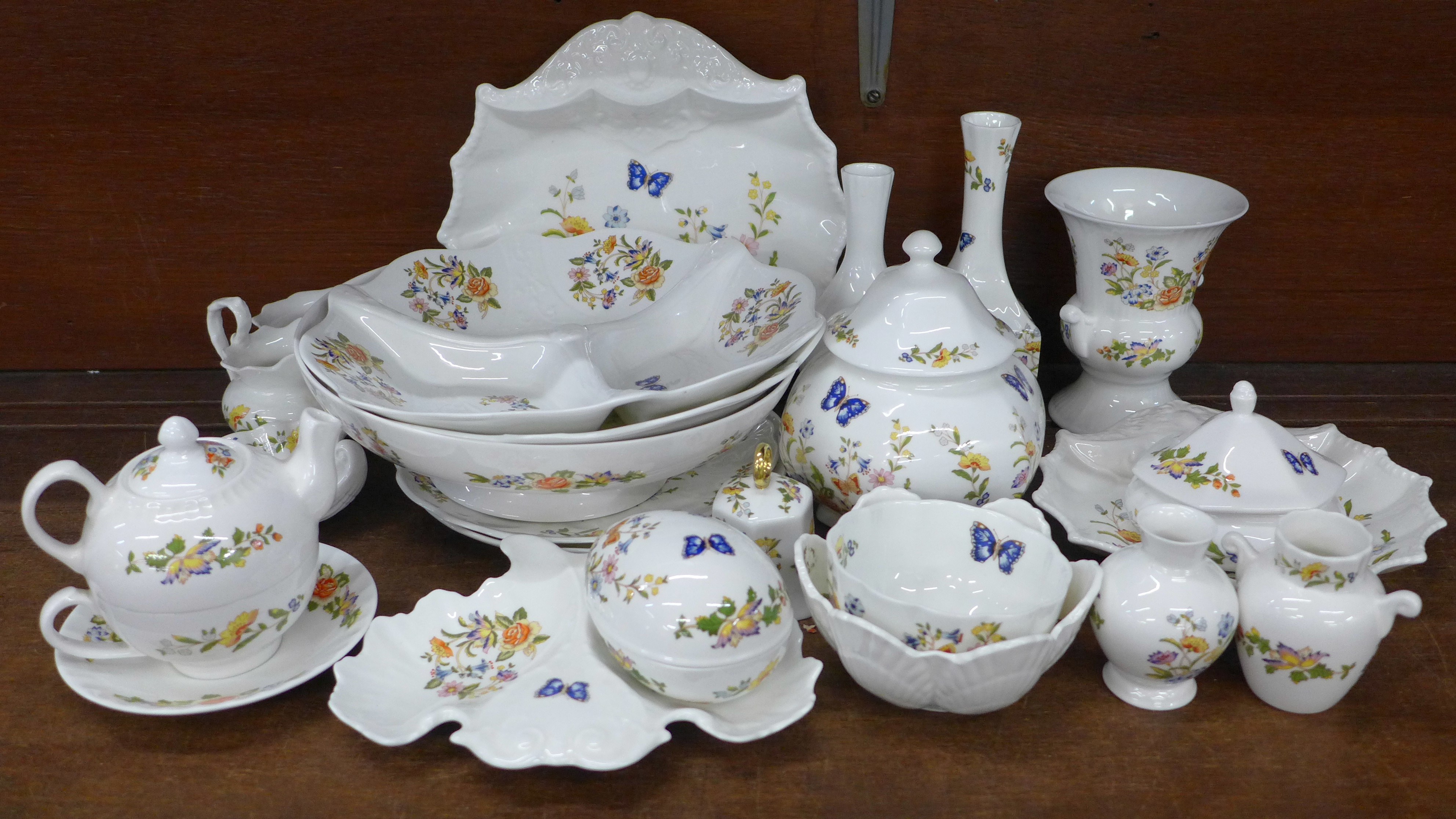 A collection of early Aynsley Cottage Garden china, includes shell shaped dish, three lidded pots,