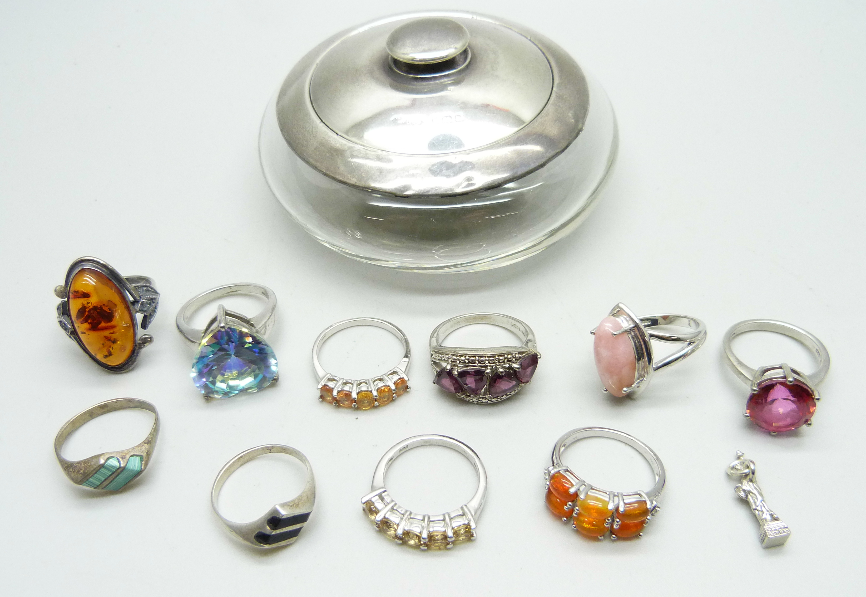 Ten silver gem set and stone set rings, a silver topped jar and a silver charm
