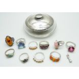 Ten silver gem set and stone set rings, a silver topped jar and a silver charm