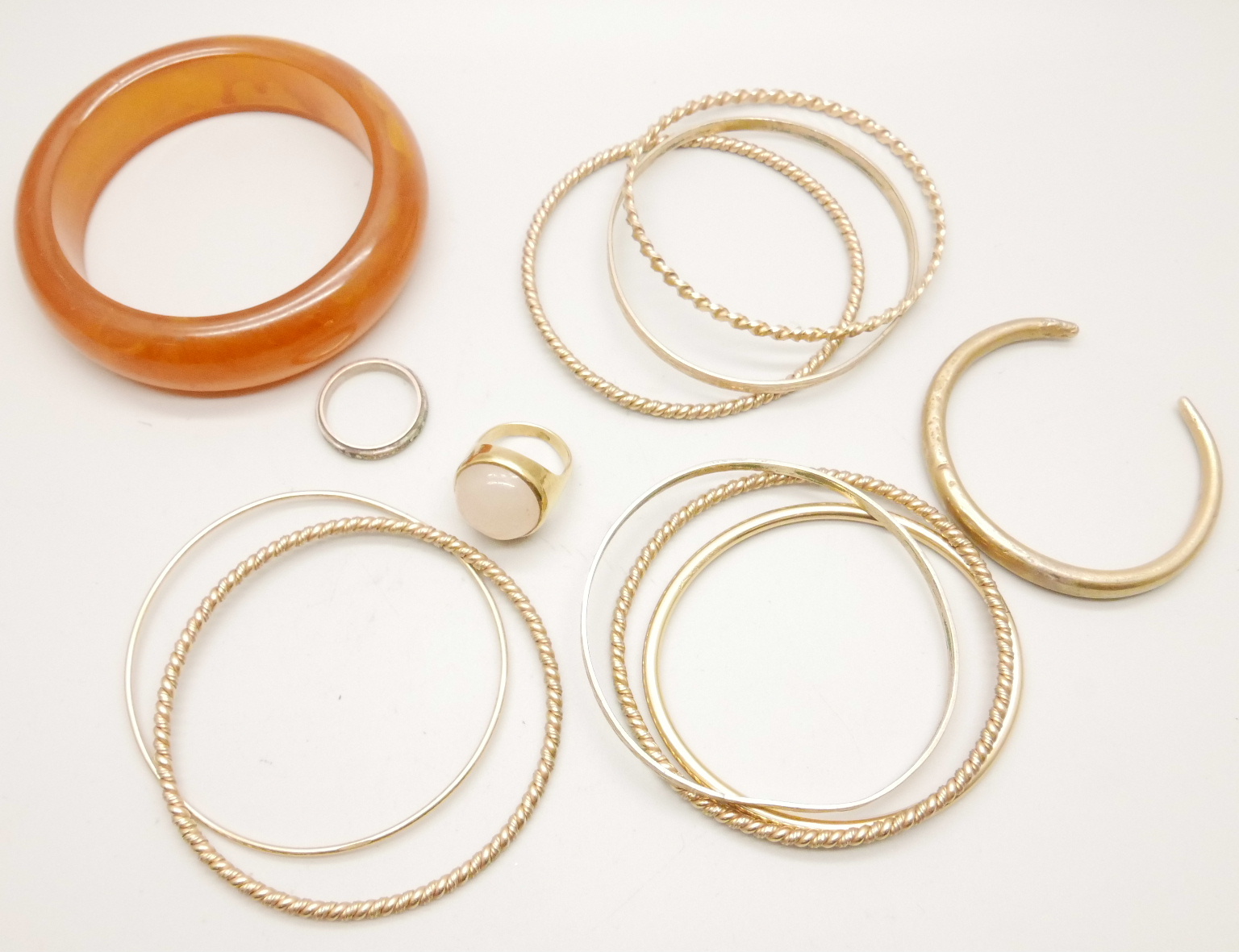 A collection of gold tone bangles and a ring, and one other bangle