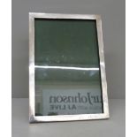 A silver photograph frame, 18.5cm wide