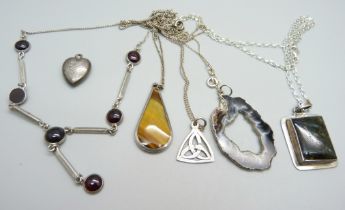 A silver necklace, a silver locket, a silver and tigers eye pendant and chain, other chains and
